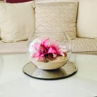 Flowers in sand with rock bowl table centrepiece