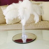 White feathers in vase table centrepiece