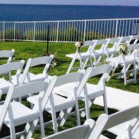 White Chairs and Aisle Flowers