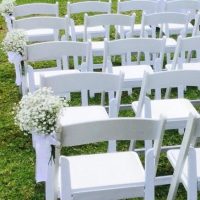 White chairs with flower bouquet