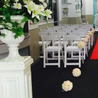 White chairs with pom poms